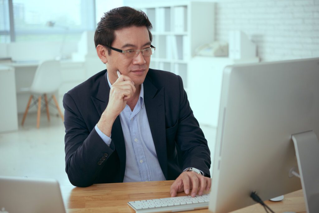 Business owner reviewing IT service options with consultant.